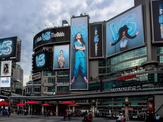Large digital billboards across the front of a downtown shopping centre